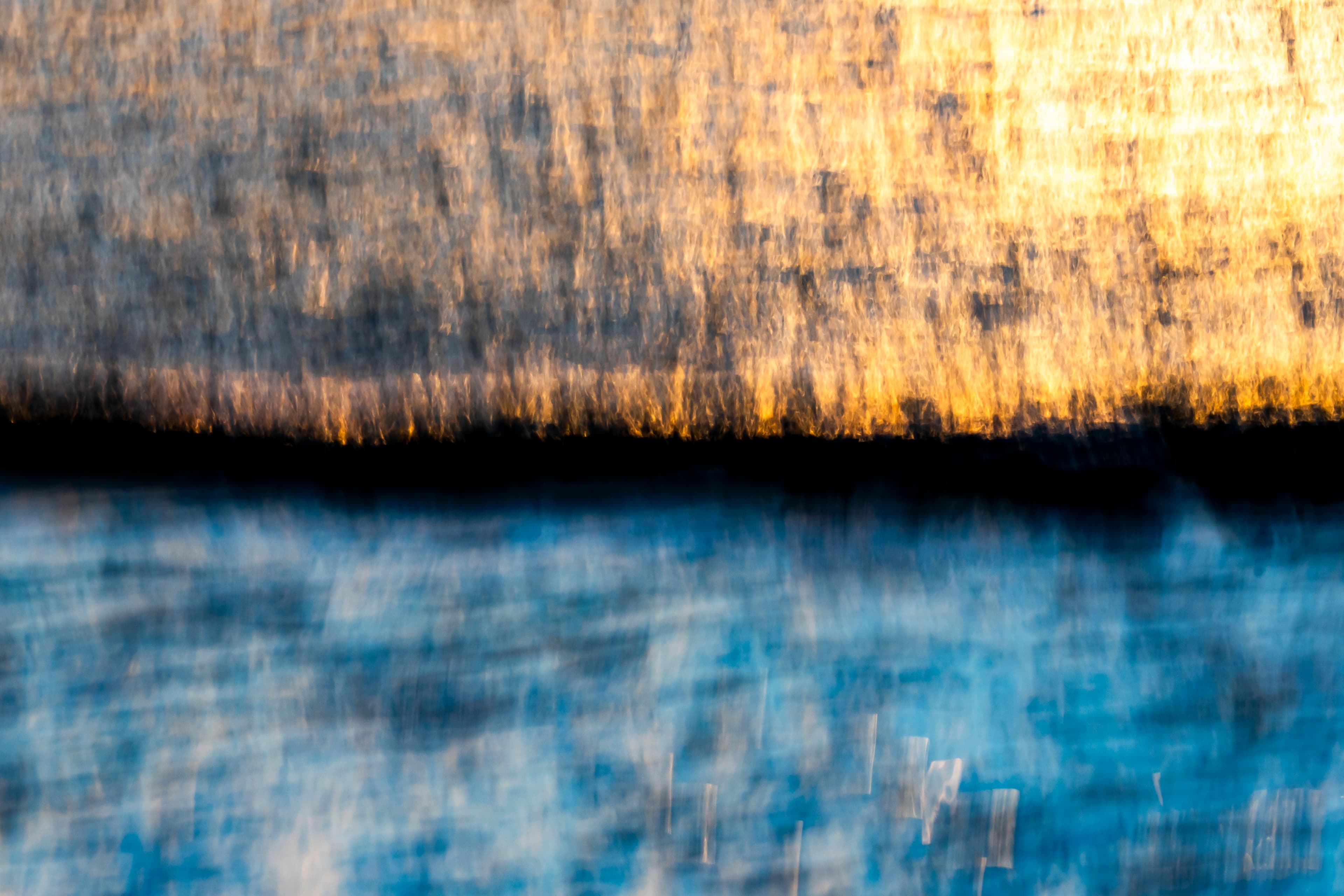 Amber and blue motion-blurred water horizon — fine art ocean photography print, Whangamata NZ.